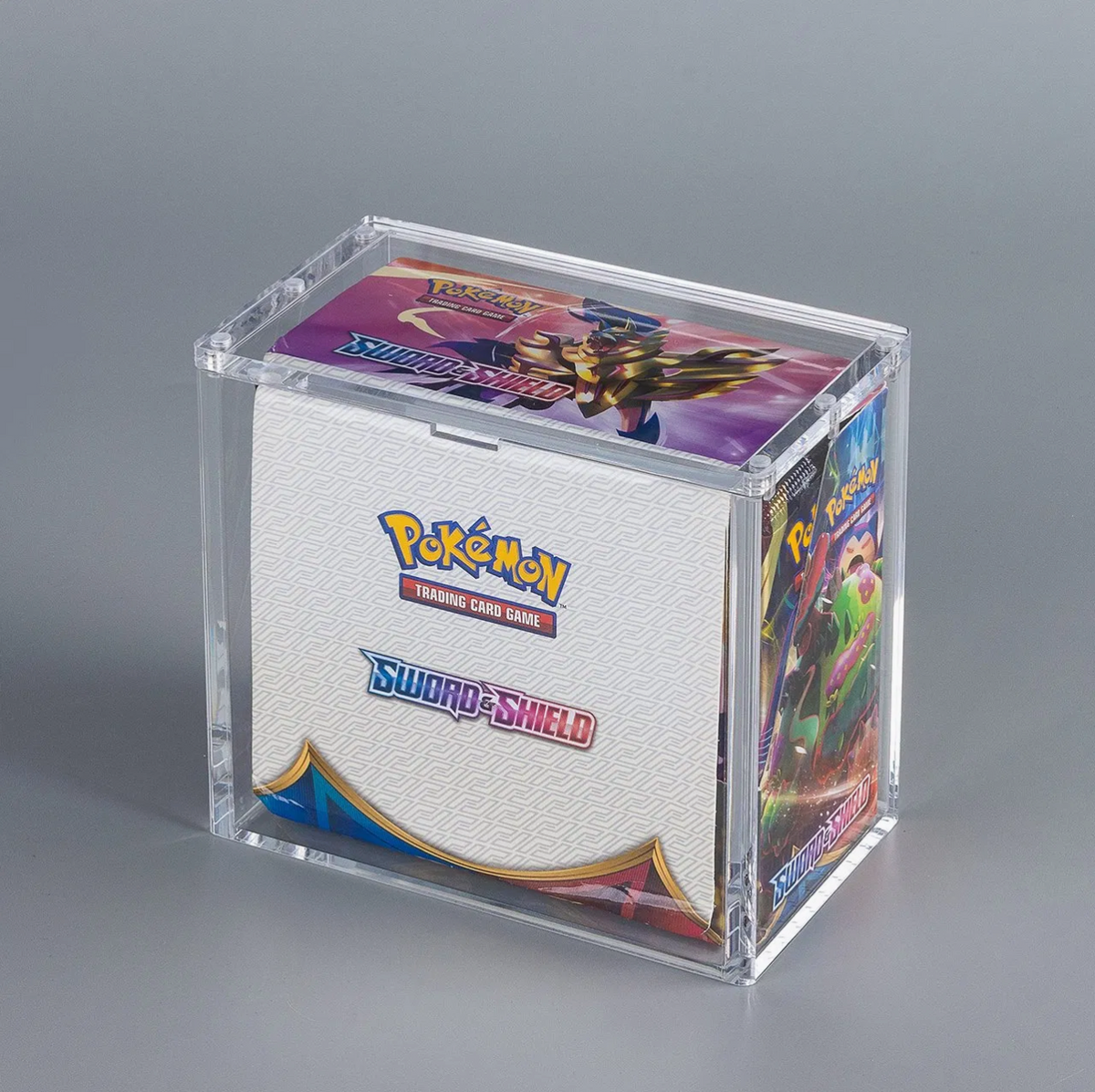 Acrylic display case with an English Pokémon Sword & Shield booster box shown for reference.